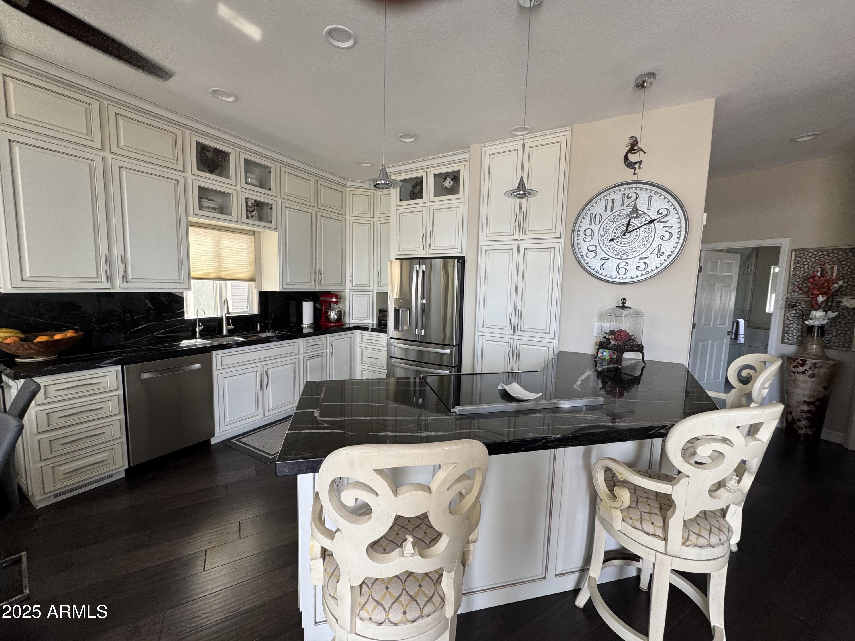 1279 South Sioux Drive Apache Junction, AZ 85119 - Photo 10 of 34 a kitchen with granite countertop a sink a stove a dining table and chairs