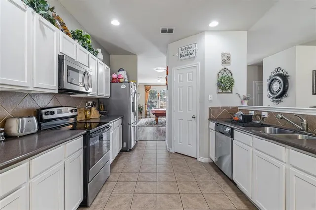 a kitchen with stainless steel appliances granite countertop a refrigerator sink and cabinets