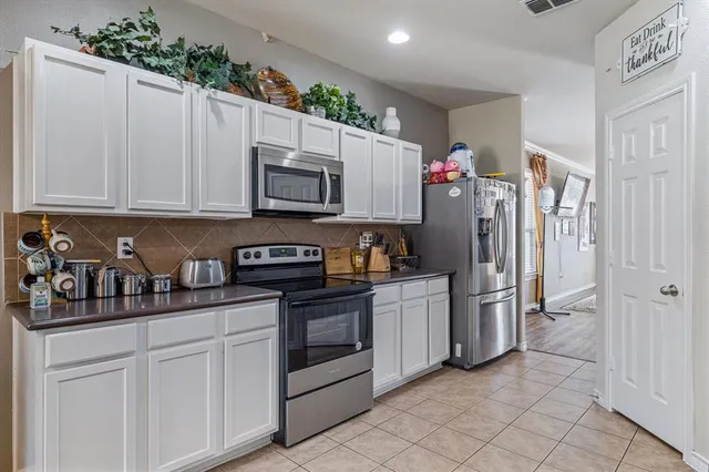 a kitchen with stainless steel appliances granite countertop a sink and a cabinets