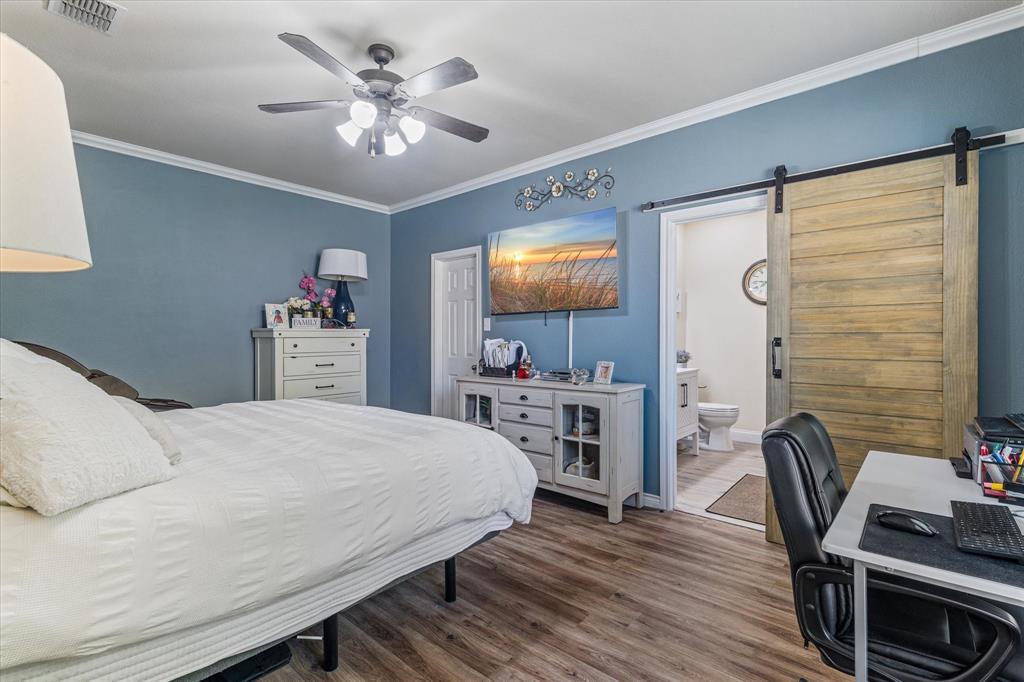 503 Sundrop Lane Fate, TX 75087 - Photo 16 of 28 a bedroom with a bed and a desk