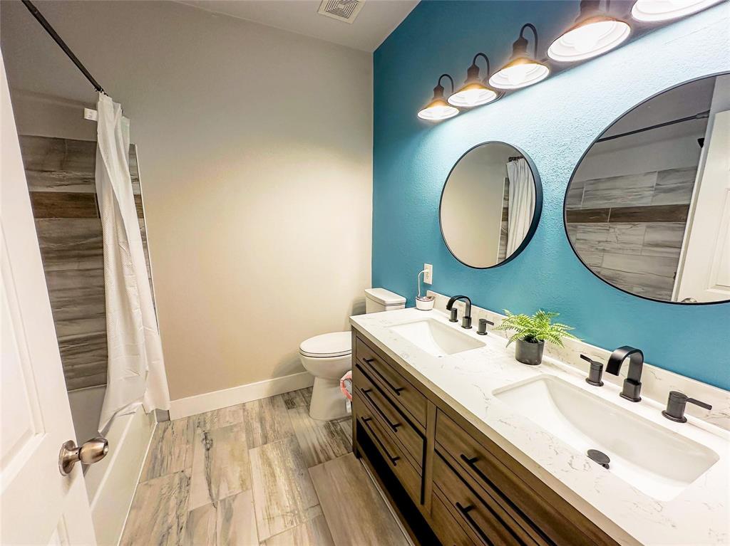 503 Sundrop Lane Fate, TX 75087 - Photo 18 of 28 a bathroom with a sink mirror and toilet