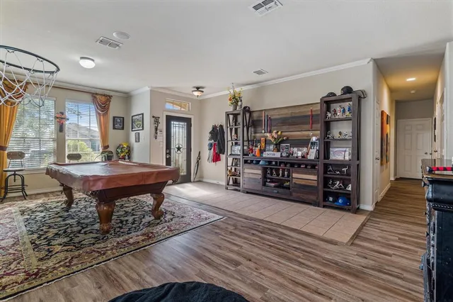 a living room with furniture a flat screen tv and a floor to ceiling window