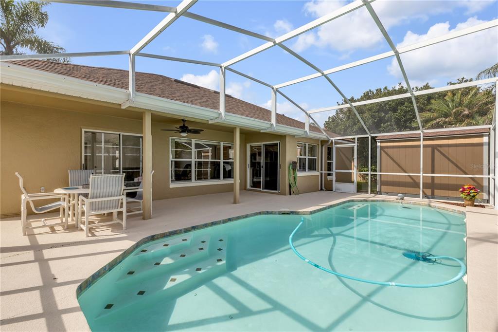 12232 Bronson Way Orlando, FL 32824 - Photo 6 of 32 a view of a patio with table and chairs and potted plants
