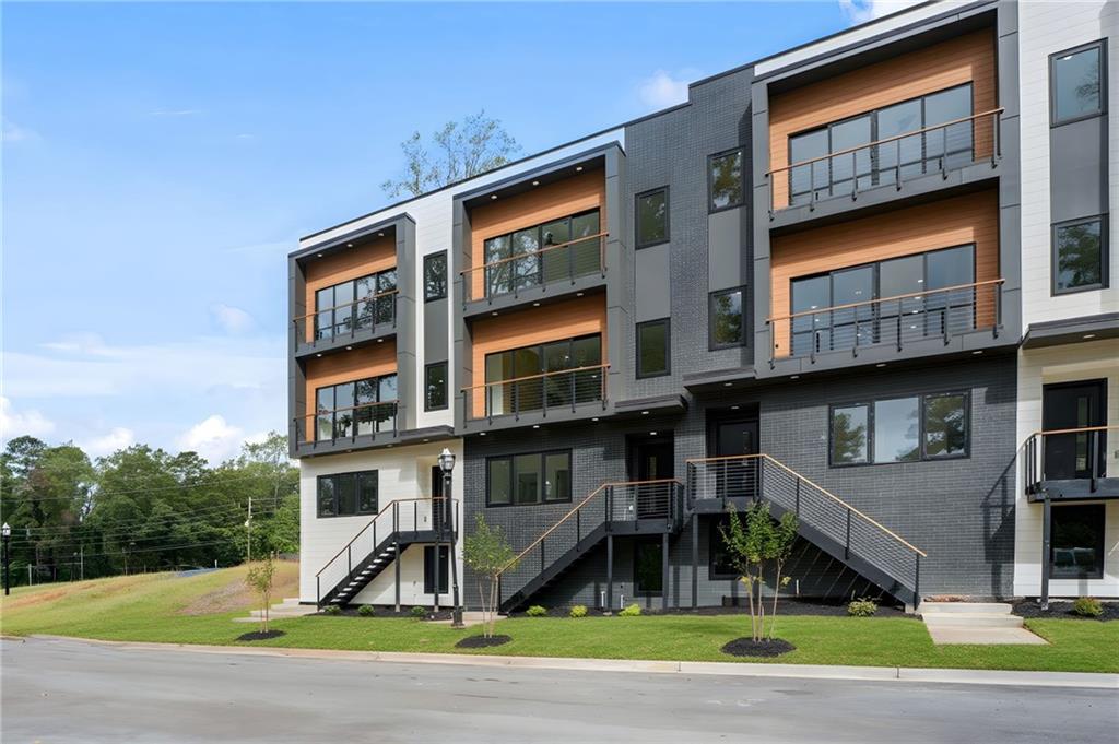 a front view of a residential apartment building with a yard