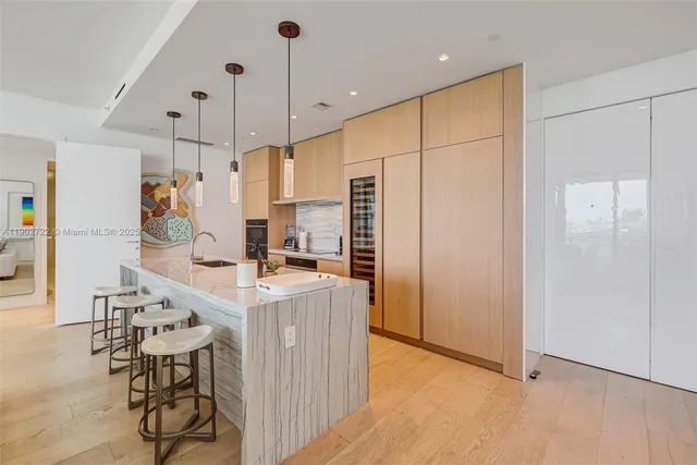 a living room with patio furniture and a wooden floor