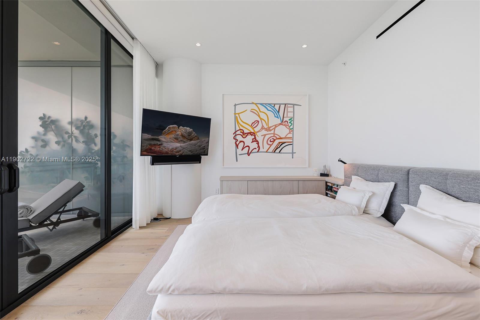 8701 Collins Avenue, Unit 904 Miami Beach, FL 33154 - Photo 28 of 73 a bedroom with a bed and painting on the wall