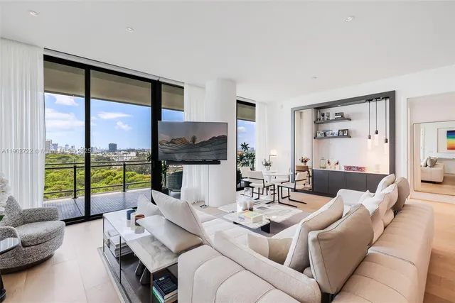 a living room with furniture and a floor to ceiling window