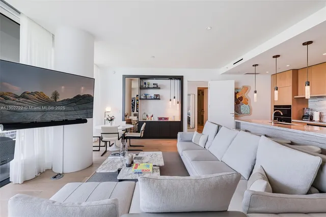 a living room with furniture and a floor to ceiling window