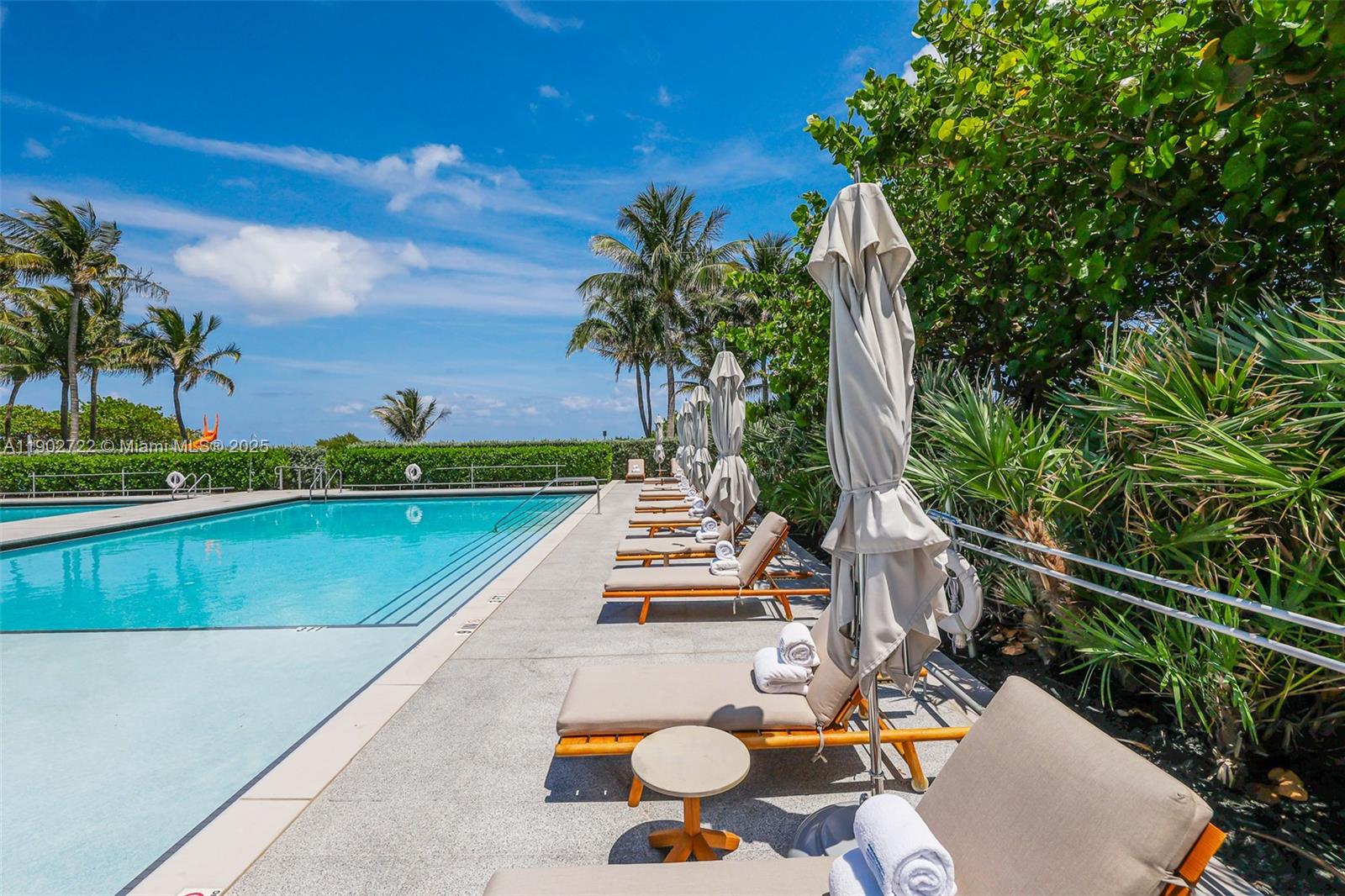 8701 Collins Avenue, Unit 904 Miami Beach, FL 33154 - Photo 56 of 73 a view of swimming pool with chairs