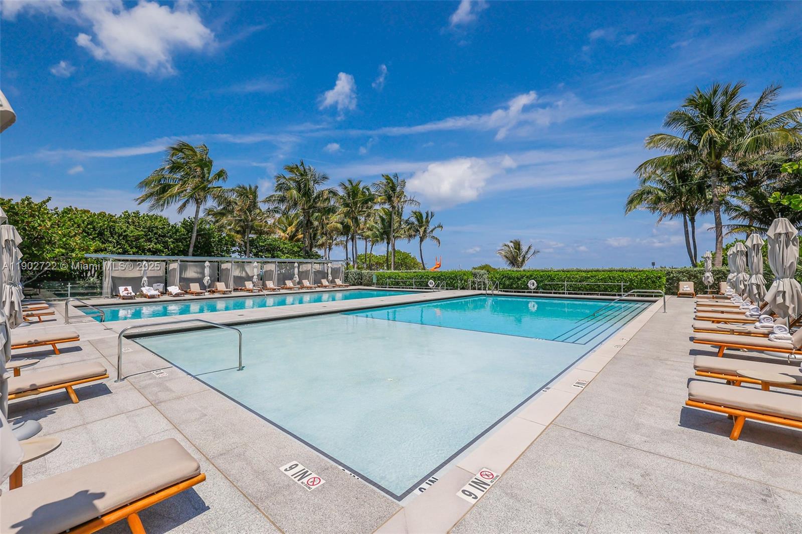 8701 Collins Avenue, Unit 904 Miami Beach, FL 33154 - Photo 57 of 73 a view of swimming pool with a table and chairs
