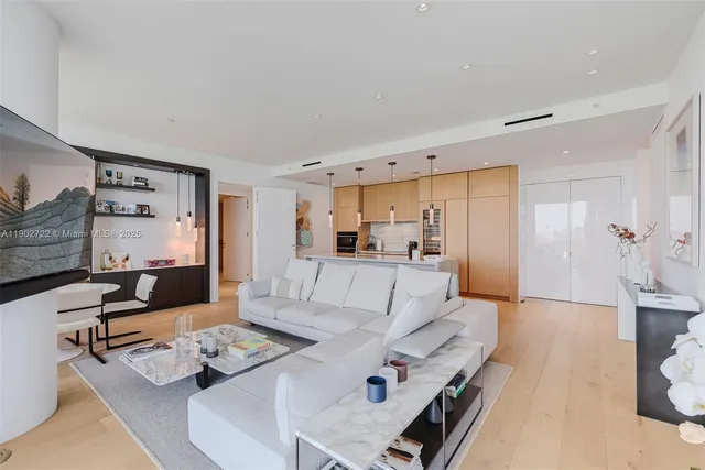 a living room with furniture and a floor to ceiling window