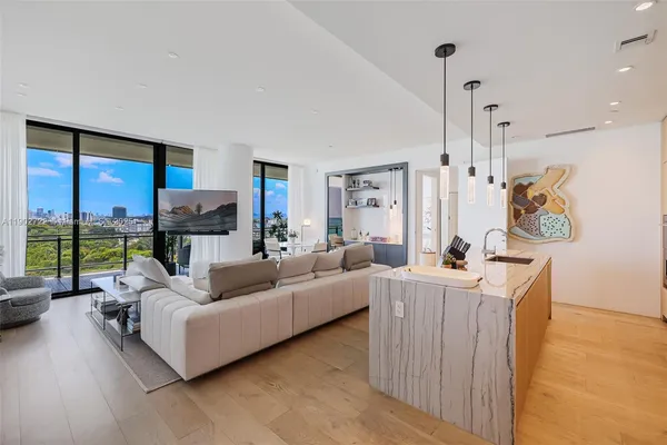 a kitchen with kitchen island a counter top space a sink stainless steel appliances and cabinets