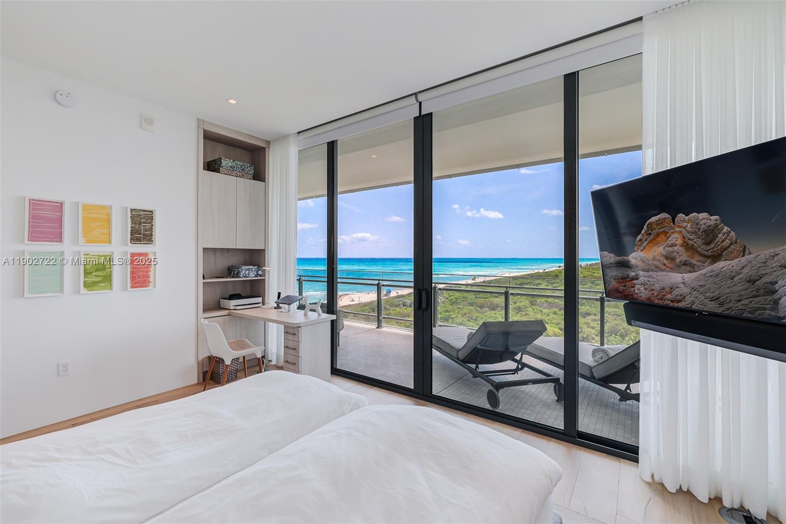 8701 Collins Avenue, Unit 904 Miami Beach, FL 33154 - Photo 10 of 73 a living room with furniture and a floor to ceiling window