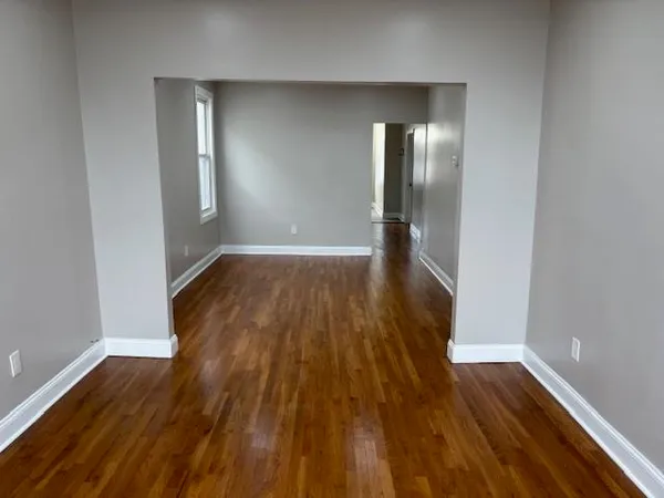 a view of a room with wooden floor