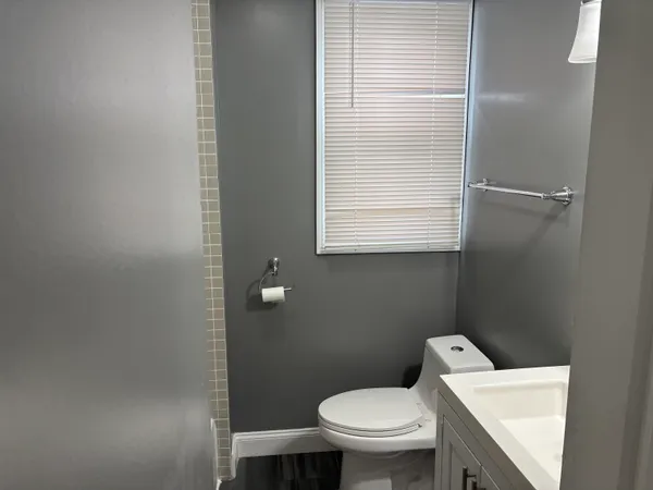 a white toilet sitting next to a bathroom sink