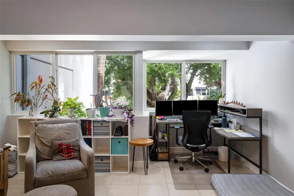 a work room with furniture and a potted plant