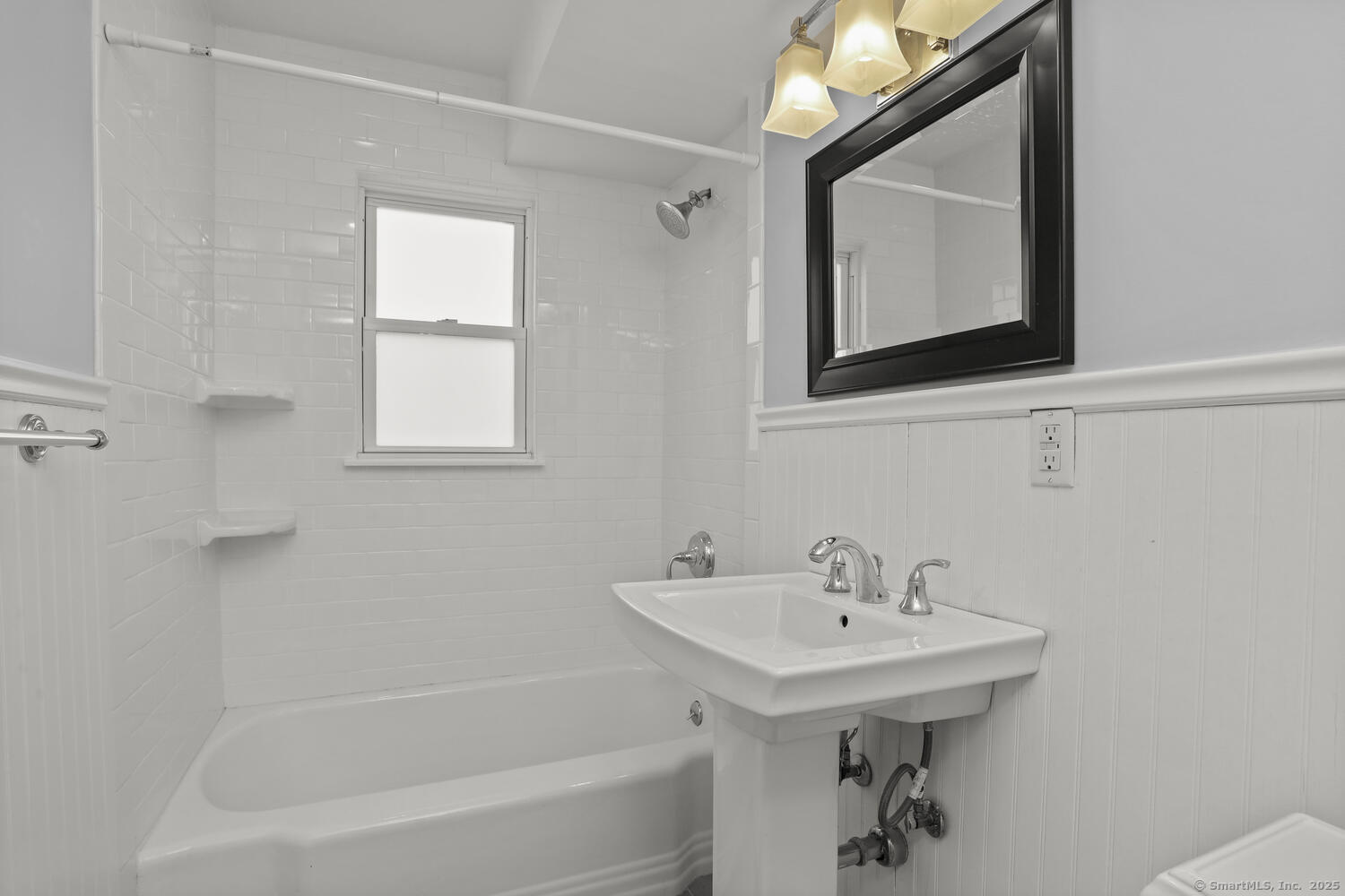 236 Glenbrook Road, Unit 13A Stamford, CT 06906 - Photo 11 of 14 a bathroom with a sink a mirror and a bathtub