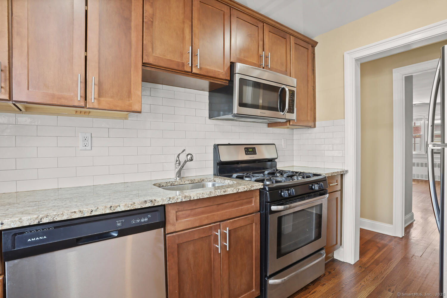 236 Glenbrook Road, Unit 13A Stamford, CT 06906 - Photo 2 of 14 a kitchen with stainless steel appliances granite countertop white cabinets a sink and dishwasher