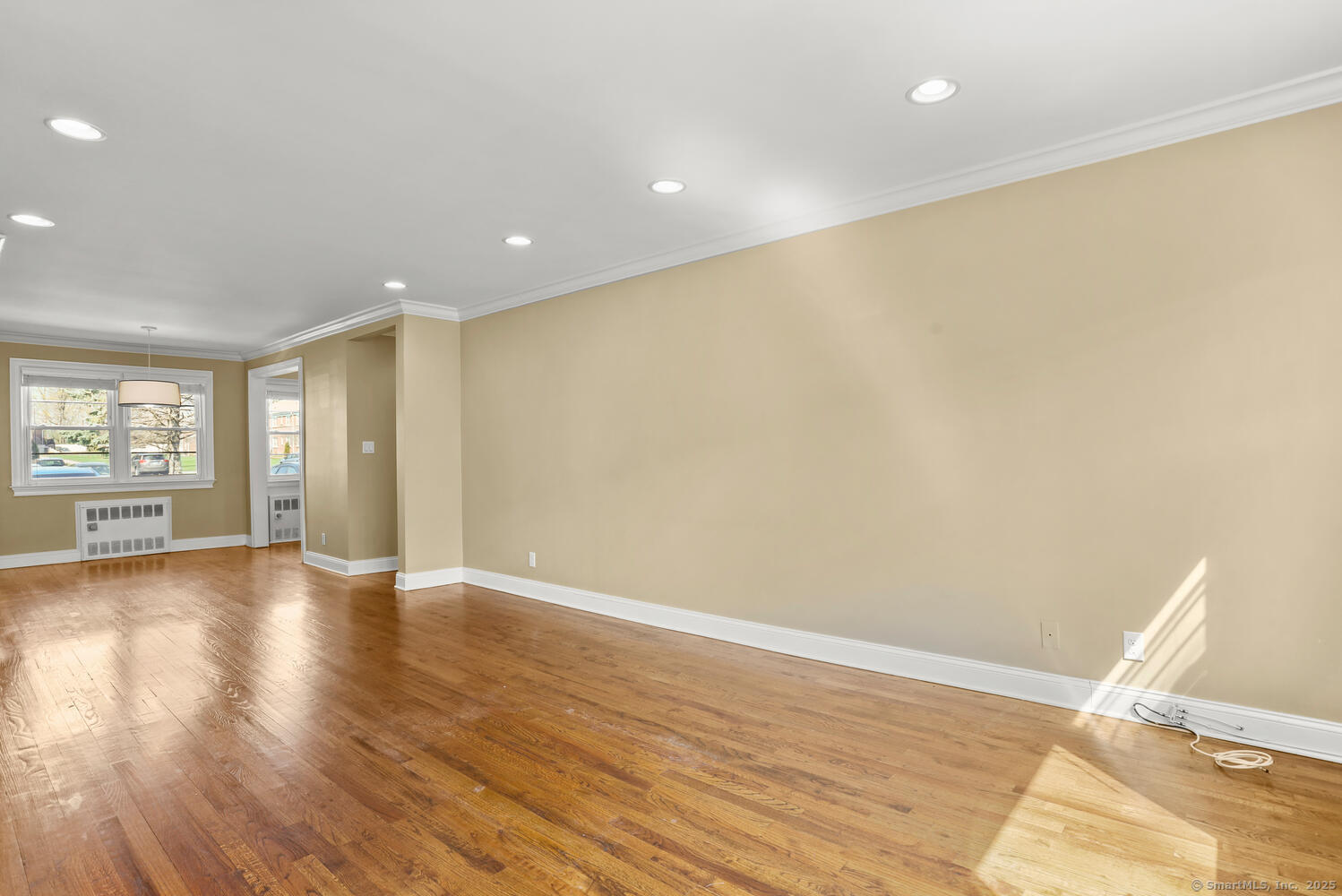 236 Glenbrook Road, Unit 13A Stamford, CT 06906 - Photo 7 of 14 a view of an empty room with wooden floor and a window