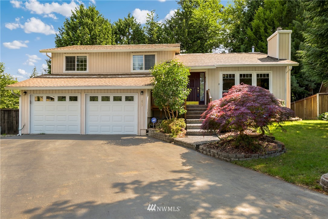 1823 175th Place Southeast Bothell, WA 98012 - Photo 1 of 24 a front view of a house with a garden