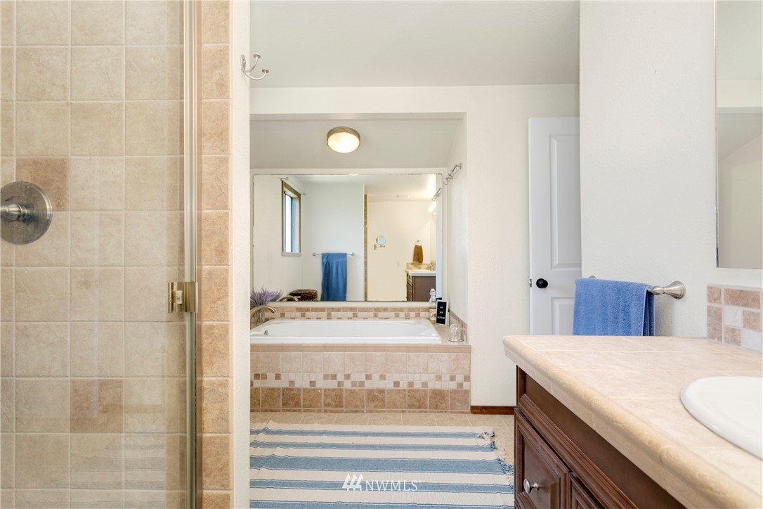 1823 175th Place Southeast Bothell, WA 98012 - Photo 13 of 24 a bathroom with a granite countertop sink and a mirror
