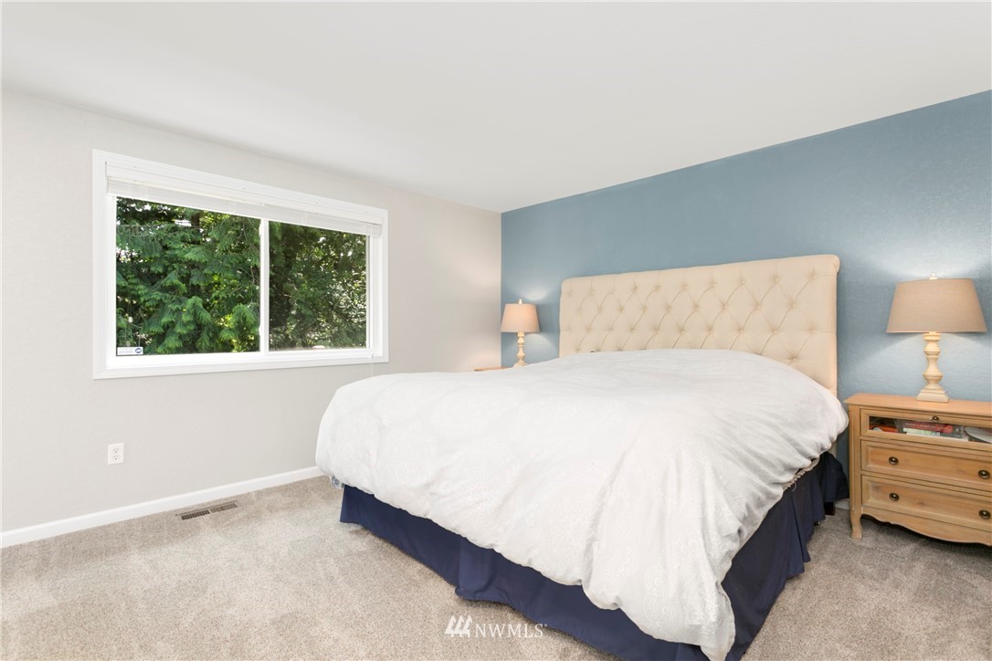 1823 175th Place Southeast Bothell, WA 98012 - Photo 14 of 24 a large bed sitting in a bedroom next to a window