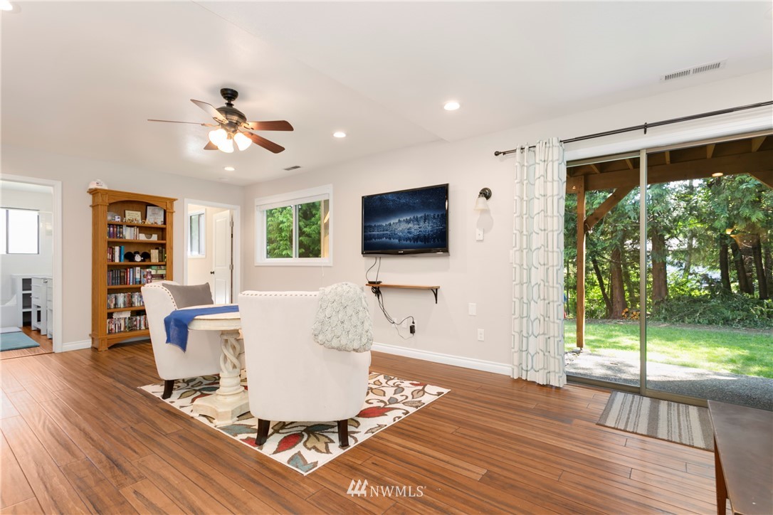 1823 175th Place Southeast Bothell, WA 98012 - Photo 18 of 24 a living room with a flat screen tv and a floor to ceiling window