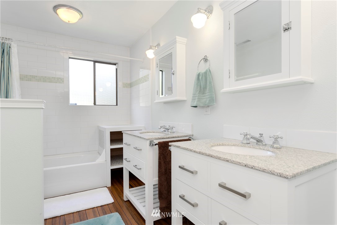 1823 175th Place Southeast Bothell, WA 98012 - Photo 20 of 24 a bathroom with a sink a vanity a mirror and a bathtub