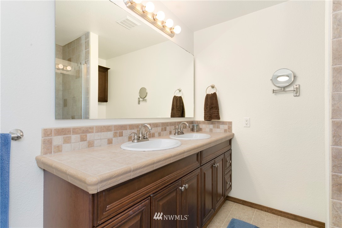 1823 175th Place Southeast Bothell, WA 98012 - Photo 21 of 24 a bathroom with a sink and a mirror