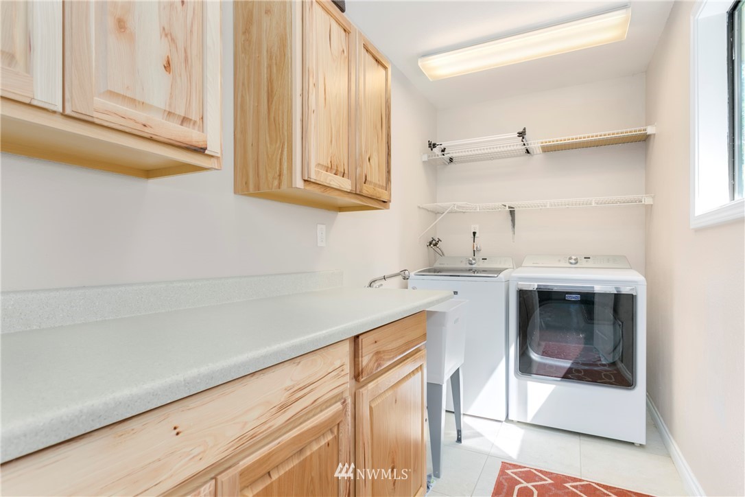 1823 175th Place Southeast Bothell, WA 98012 - Photo 22 of 24 a kitchen with a white cabinets and white appliances