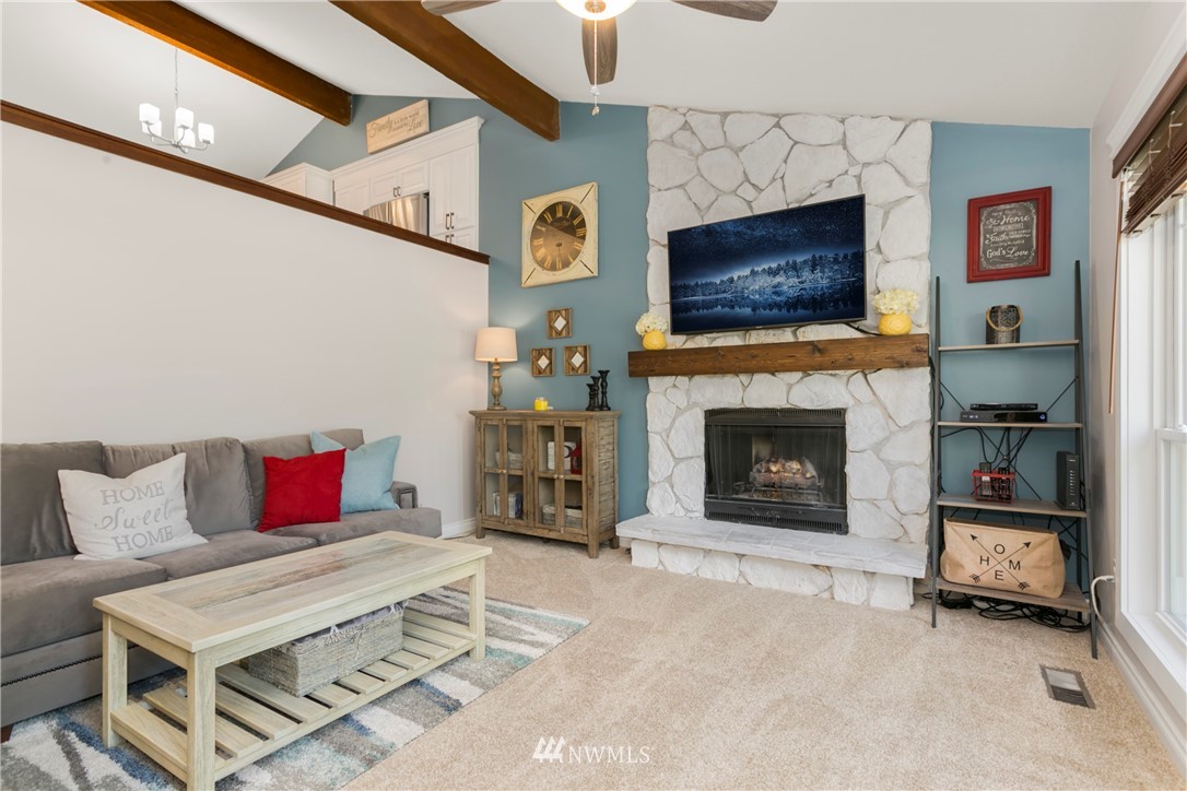 1823 175th Place Southeast Bothell, WA 98012 - Photo 5 of 24 a living room with furniture a flat screen tv and a fireplace