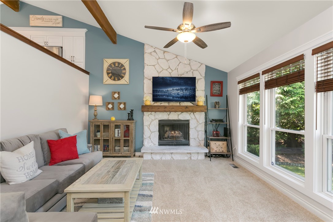 1823 175th Place Southeast Bothell, WA 98012 - Photo 6 of 24 a living room with furniture a fireplace and a flat screen tv