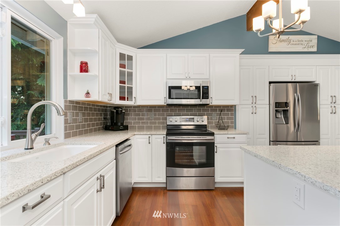1823 175th Place Southeast Bothell, WA 98012 - Photo 10 of 24 a kitchen with stainless steel appliances a sink stove and cabinets