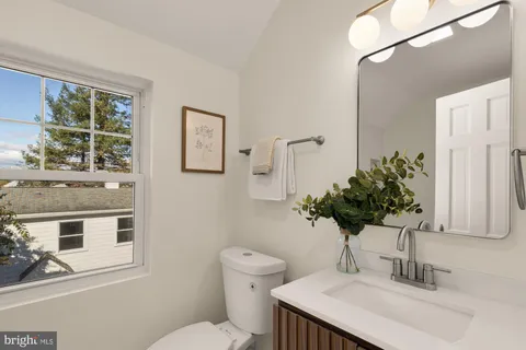 a bathroom with a sink toilet and mirror