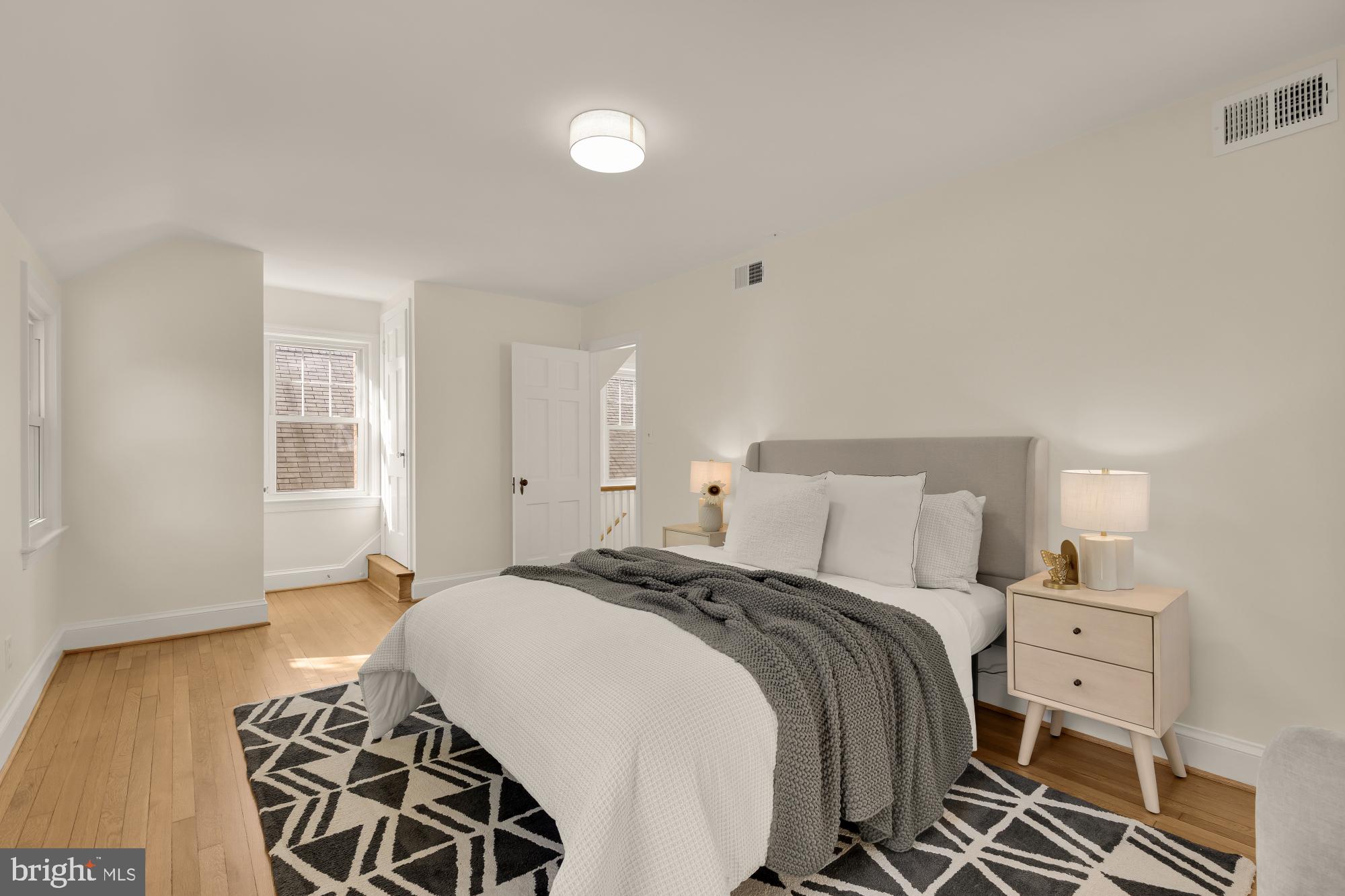 4701 Rosedale Avenue Bethesda, MD 20814 - Photo 15 of 43 a bedroom with a bed and wooden floor