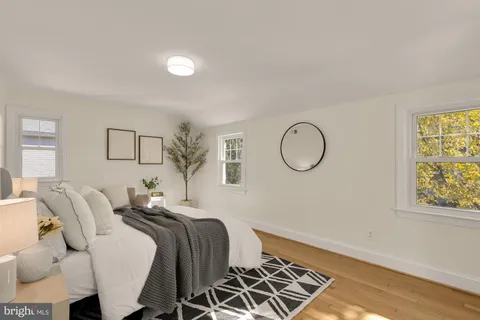 a bedroom with bed and wooden floor