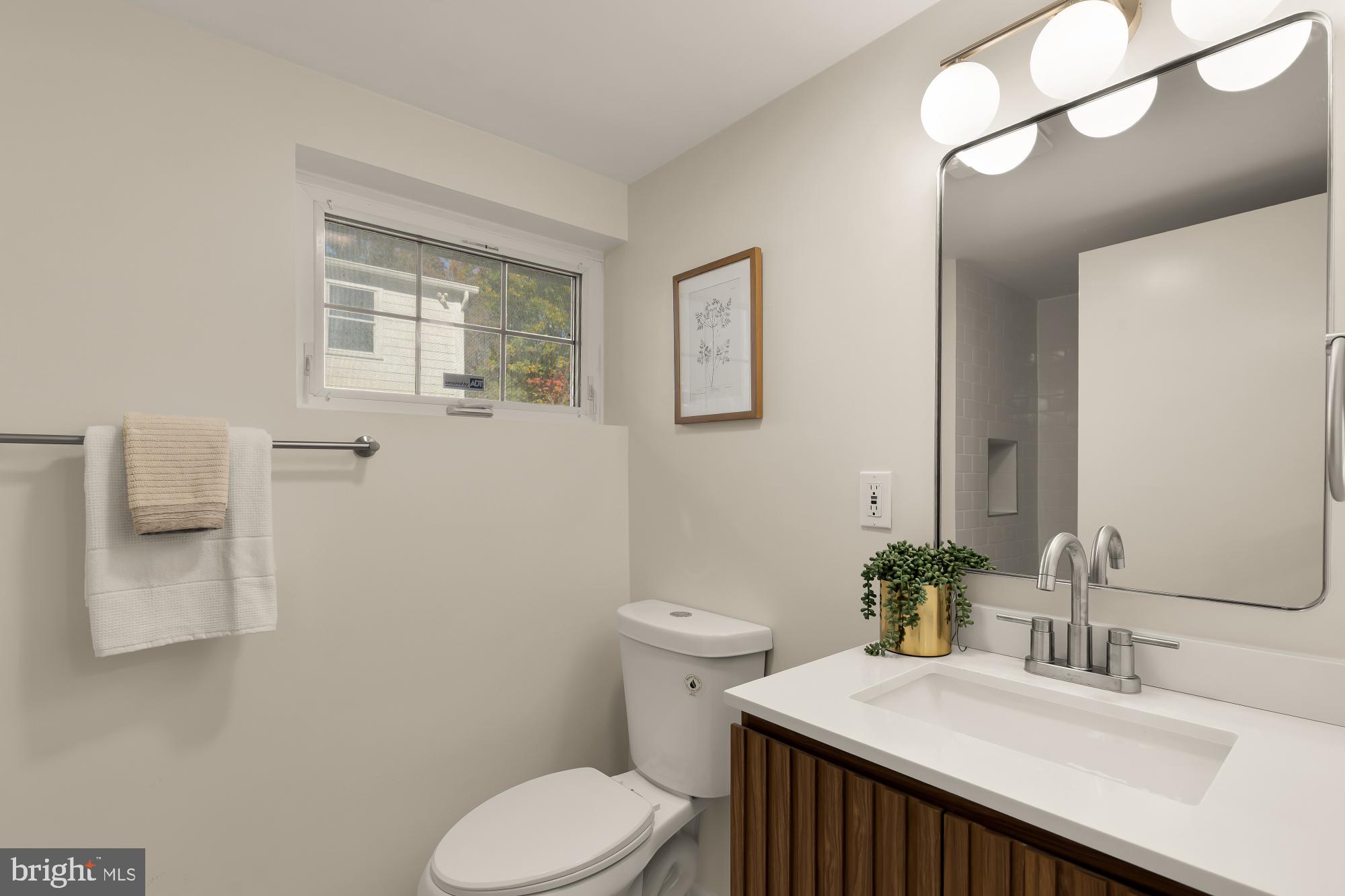 4701 Rosedale Avenue Bethesda, MD 20814 - Photo 21 of 43 a bathroom with a sink a toilet and mirror