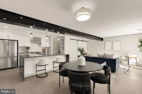 a kitchen with stainless steel appliances granite countertop a sink and a refrigerator