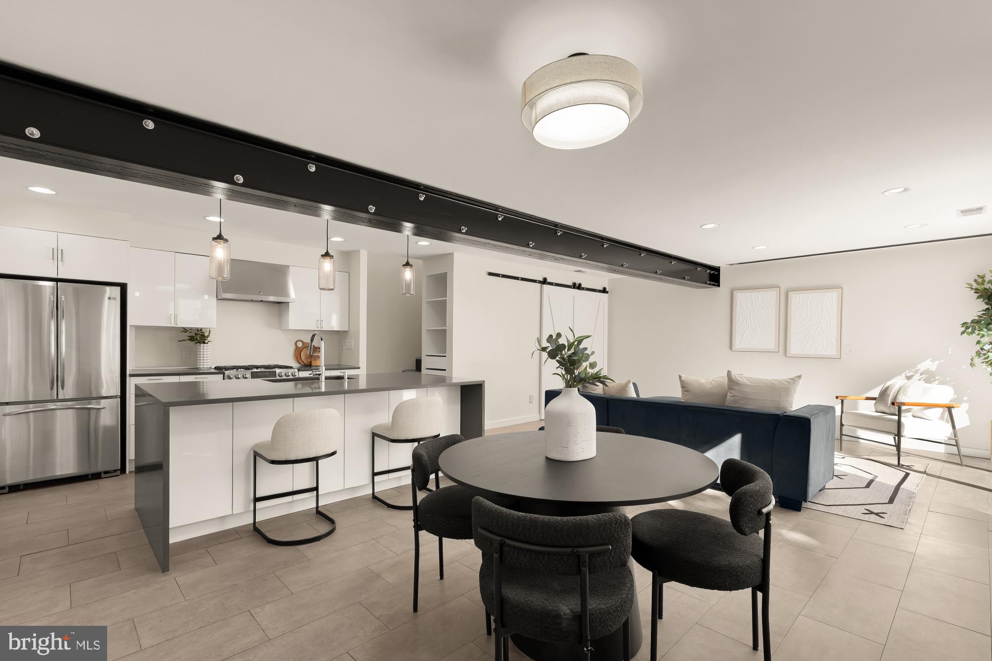 4701 Rosedale Avenue Bethesda, MD 20814 - Photo 25 of 43 a kitchen with a table chairs and white cabinets