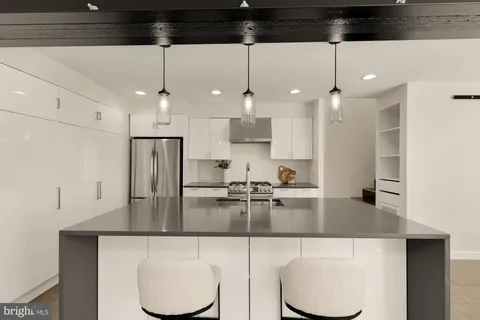 a kitchen with stainless steel appliances granite countertop a sink and stove