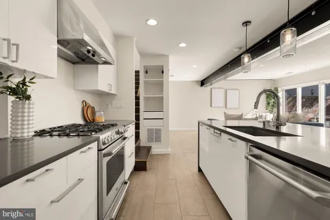 a kitchen with a stove and a sink