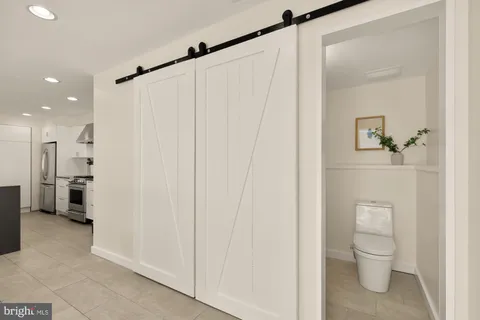 a spacious bedroom with a bed and wooden floor