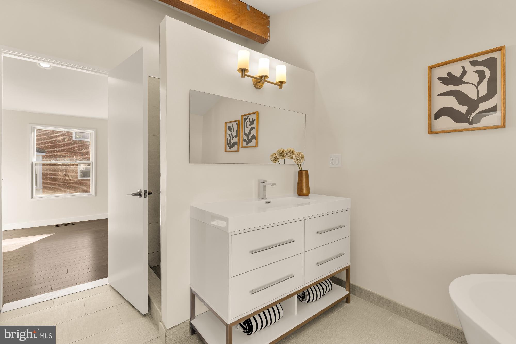 4701 Rosedale Avenue Bethesda, MD 20814 - Photo 39 of 43 a bathroom with a sink and a mirror
