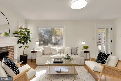 a living room with furniture potted plant and a large window