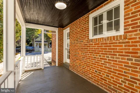 a view of front door of house with wooden floor