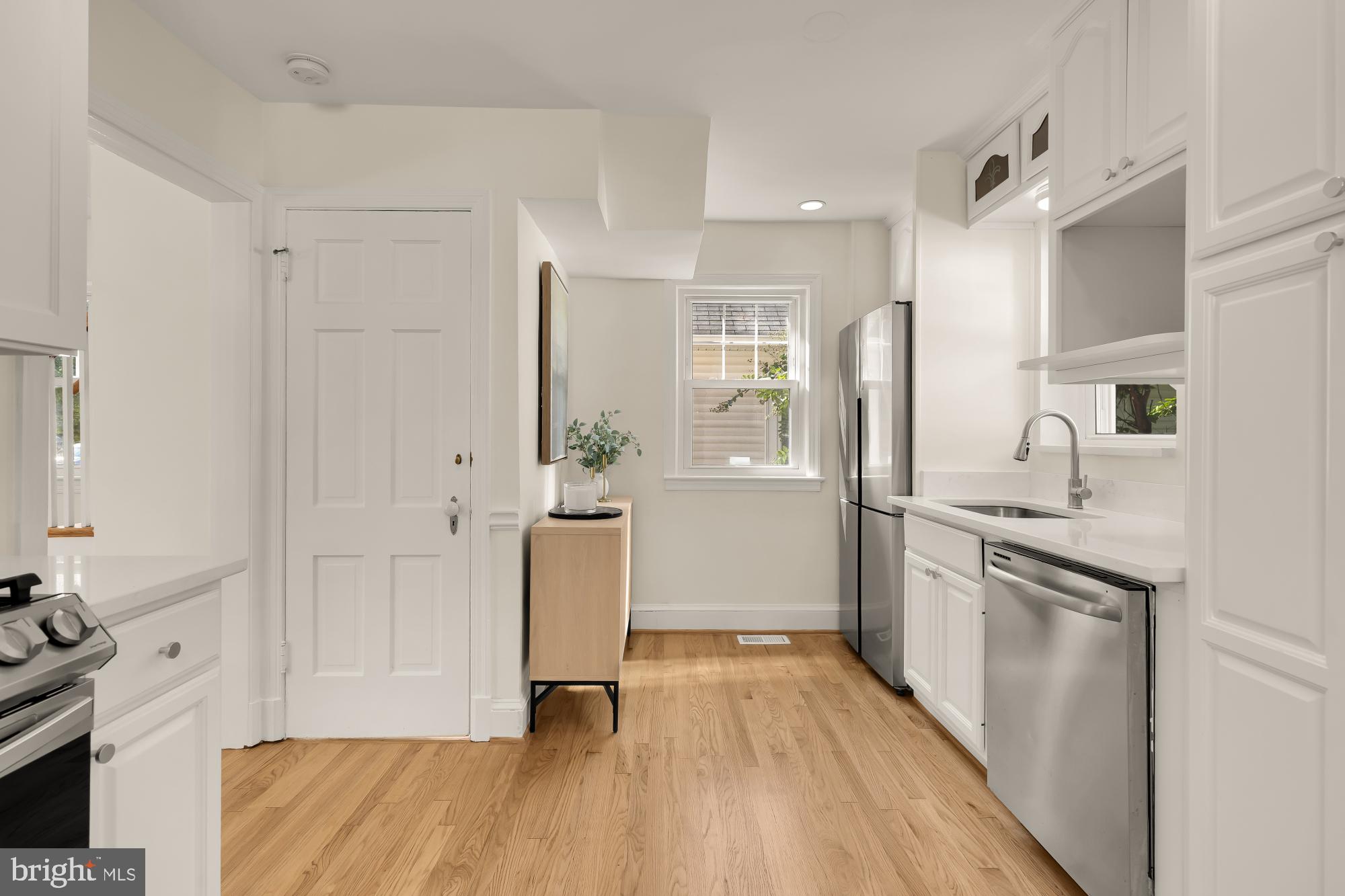 4701 Rosedale Avenue Bethesda, MD 20814 - Photo 10 of 43 a kitchen with white cabinets and stainless steel appliances