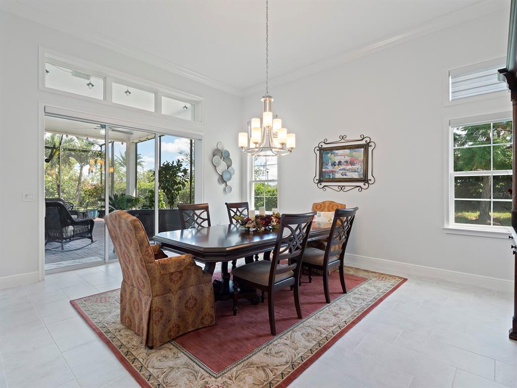 2600 Meadowedge Loop St. Cloud, FL 34772 - Photo 17 of 82 a dining room with furniture a rug and a chandelier