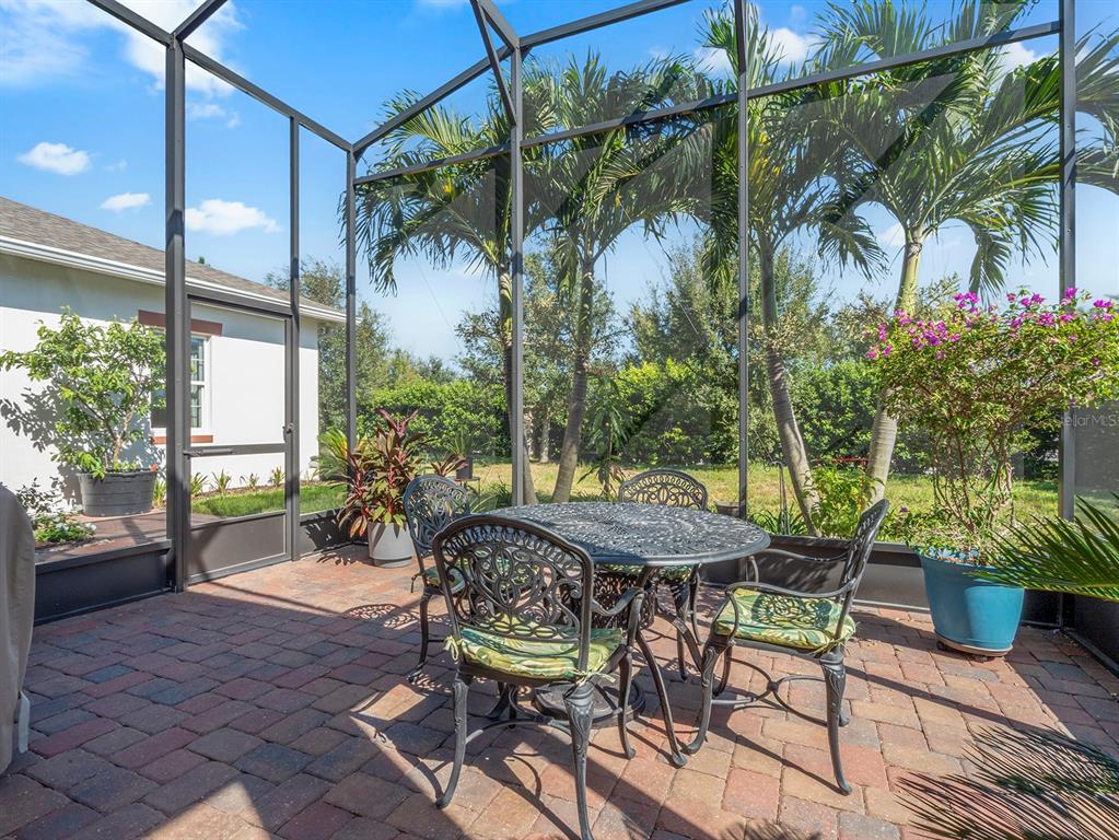 2600 Meadowedge Loop St. Cloud, FL 34772 - Photo 20 of 82 a view of a patio with table and chairs and potted plants