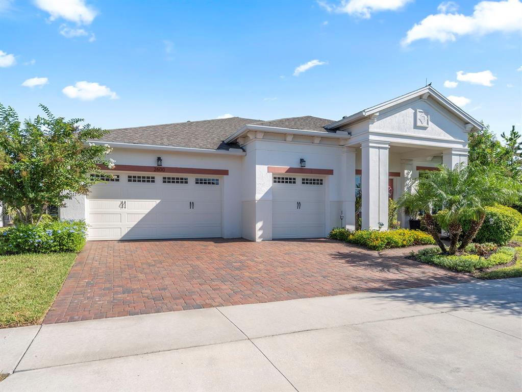 2600 Meadowedge Loop St. Cloud, FL 34772 - Photo 2 of 82 a front view of a house with garden