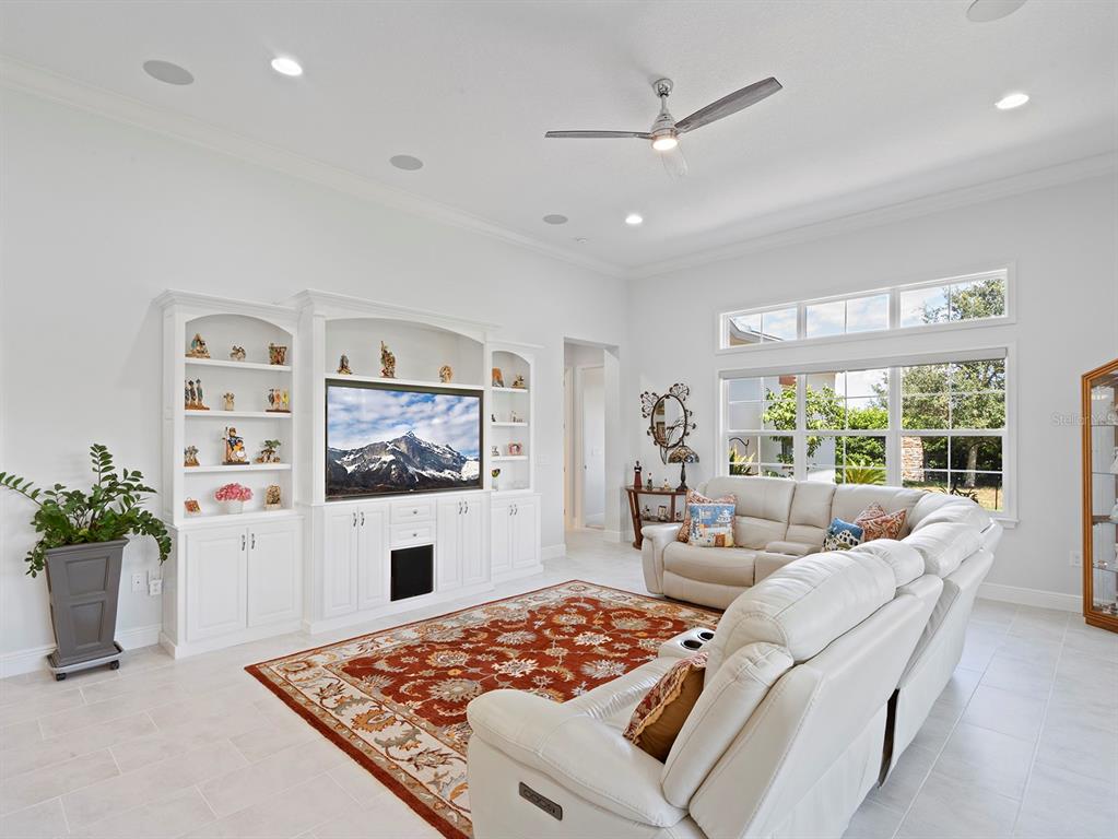 2600 Meadowedge Loop St. Cloud, FL 34772 - Photo 34 of 82 a living room with furniture a large window and a fireplace